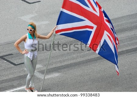 stock-photo-sepang-malaysia-march-grid-girl-holds-british-flag-during-the-opening-ceremony-of-f-99338483.jpg