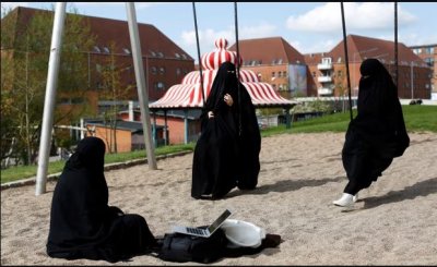 Zaynab (C), who lives in Mjølnerparken estate, sits with her friends Amira and Sabrina in Superkilen park. Photograph: Andrew Kelly/Reuters