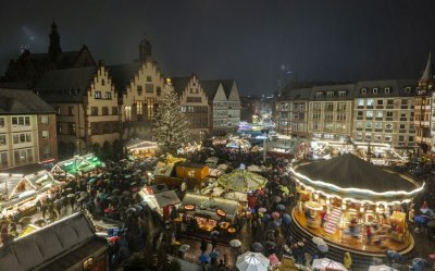 A night view of a bustling Christmas market in a city square in Germany