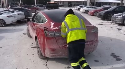 Alguien empuja un Tesla en una estación de carga de vehículos del área de Chicago, donde muchos de los vehículos eléctricos se han visto obligados a permanecer estacionados en medio de temperaturas gélidas.