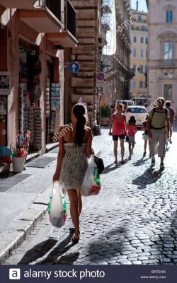 girl-walking-in-street-with-shopping-bags-rome-italy-young-woman-tourist-BRTEW5.jpg